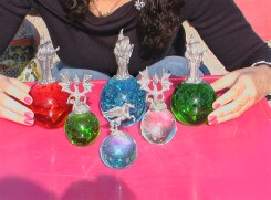 Array of glass spheres with Dragon, wizard and Pegasus figurines.